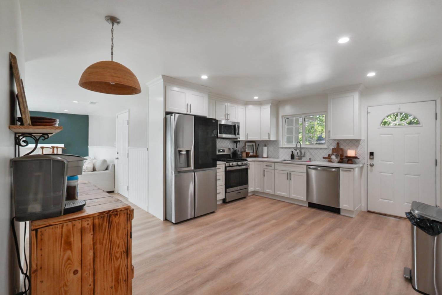 3280 Cheyenne Drive Merced, CA 95348 - Photo 2 of 17 a kitchen with stainless steel appliances granite countertop a refrigerator a stove a sink dishwasher and a refrigerator with wooden floor