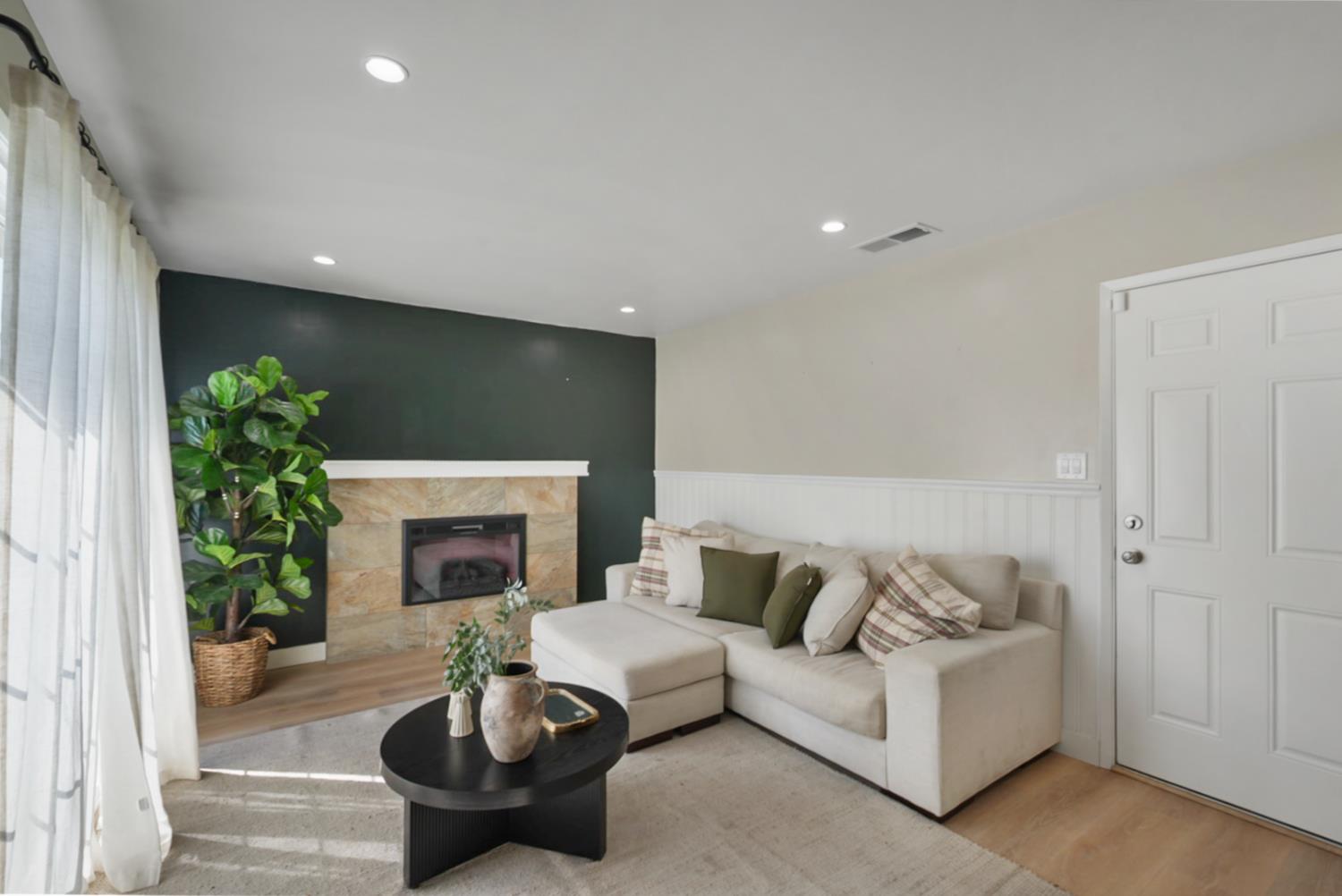 3280 Cheyenne Drive Merced, CA 95348 - Photo 5 of 17 a living room with furniture a fireplace and a potted plant
