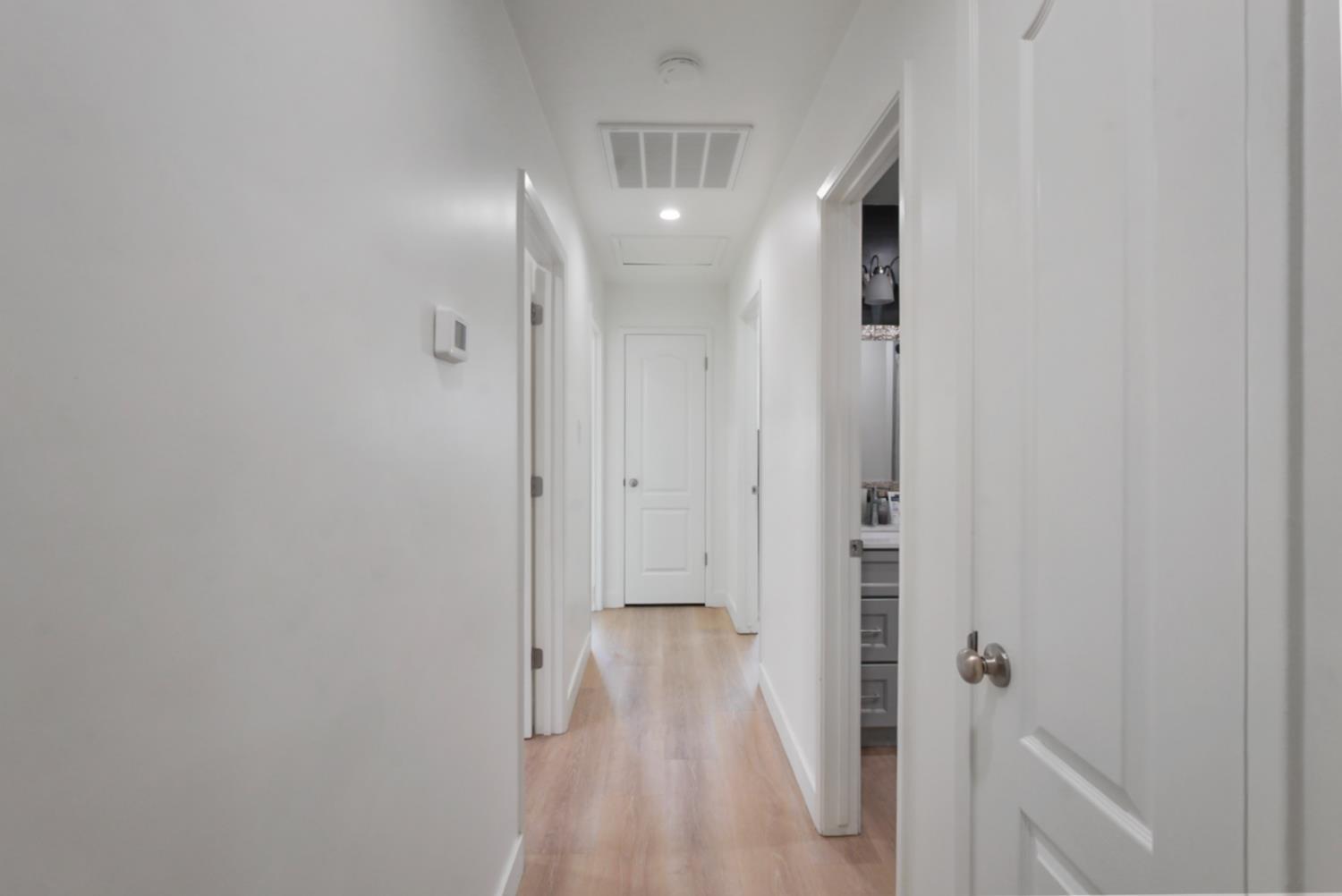 3280 Cheyenne Drive Merced, CA 95348 - Photo 8 of 17 a view of a hallway with wooden floor and staircase