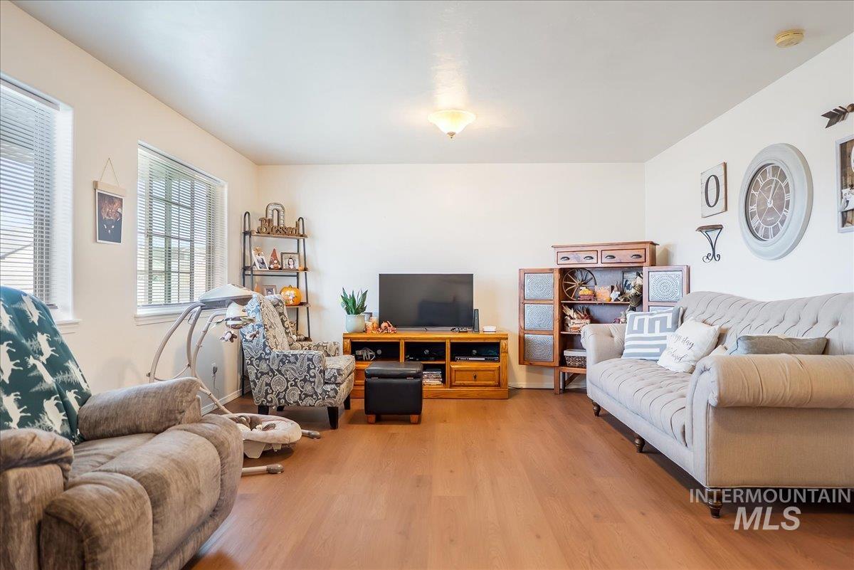 215 Little Cedar Street Hansen, ID 83334 - Photo 6 of 26 Living room with light wood-style floors and baseboards