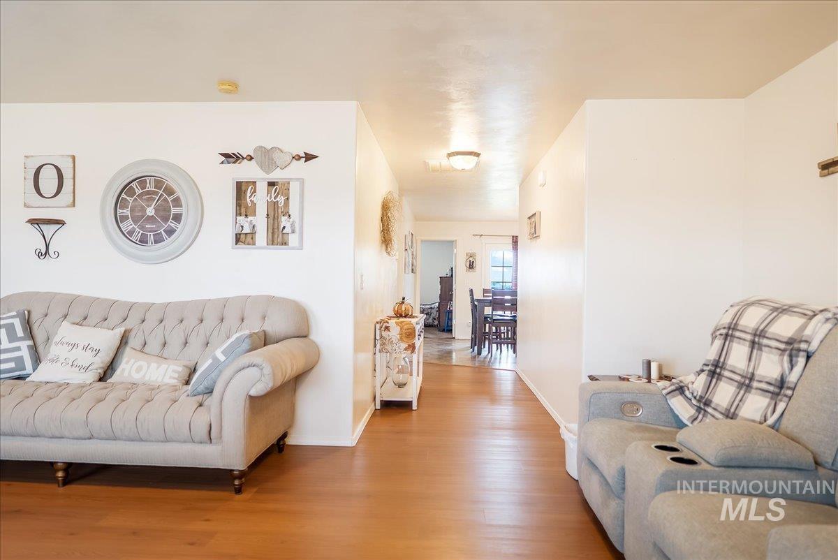 215 Little Cedar Street Hansen, ID 83334 - Photo 8 of 26 Living area featuring wood finished floors and baseboards