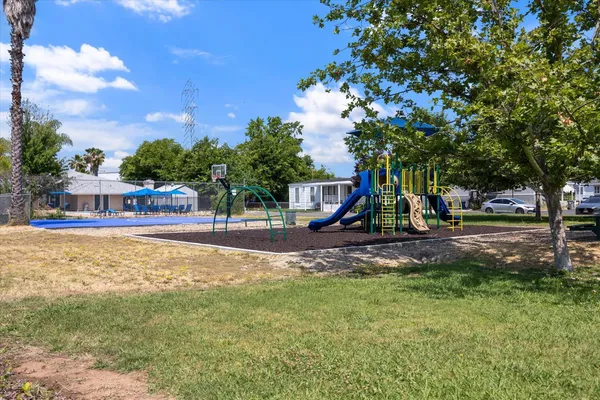 a view of a park with swings and slides