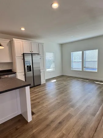 a view of a kitchen with a sink and a refrigerator