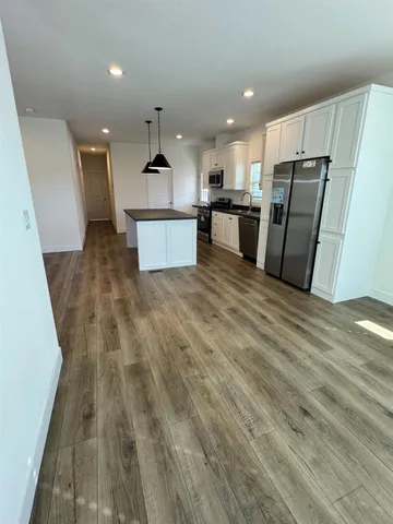 a view of kitchen with wooden floor