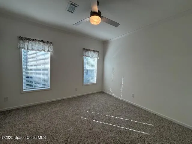 an empty room with windows and mirror