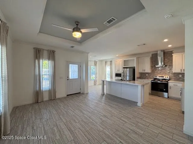 a large kitchen with kitchen island a sink stainless steel appliances and cabinets
