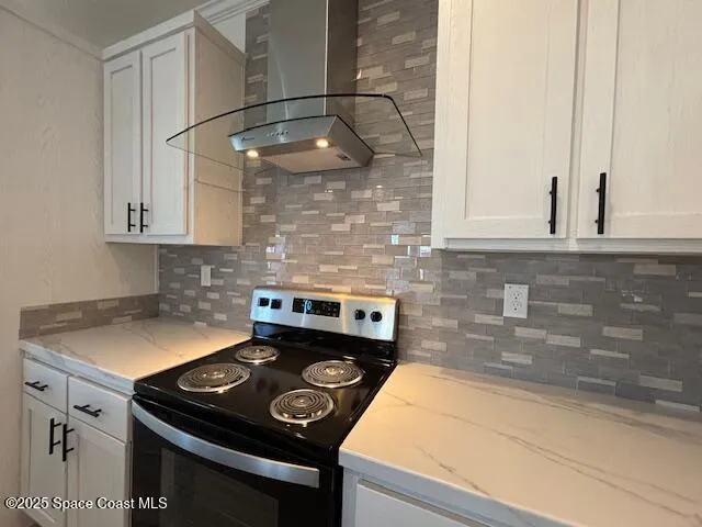 a kitchen with a stove and a white cabinet