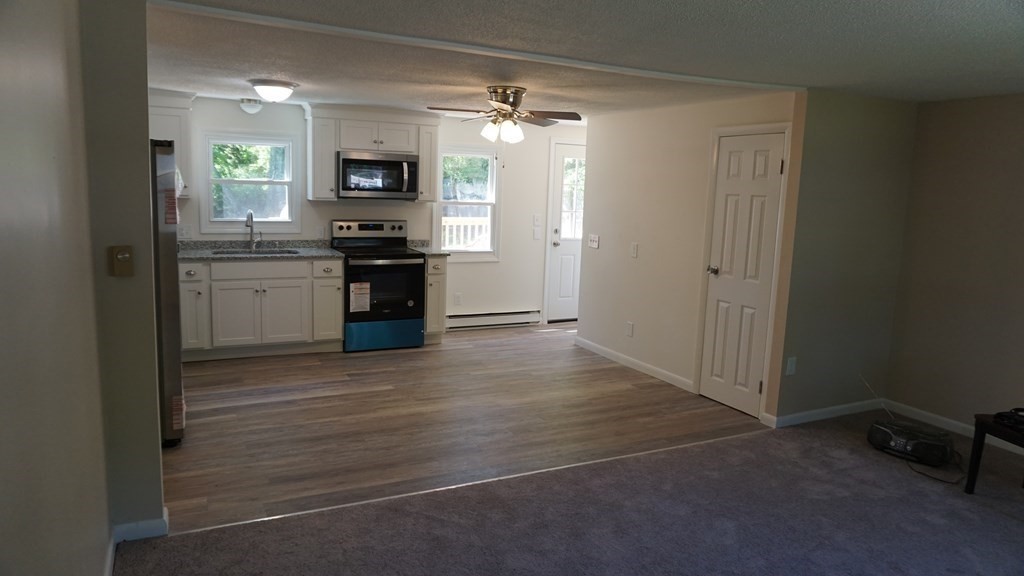 95 Sierra Vista Road Springfield, MA 01128 - Photo 4 of 28 a kitchen with a refrigerator and a stove top oven