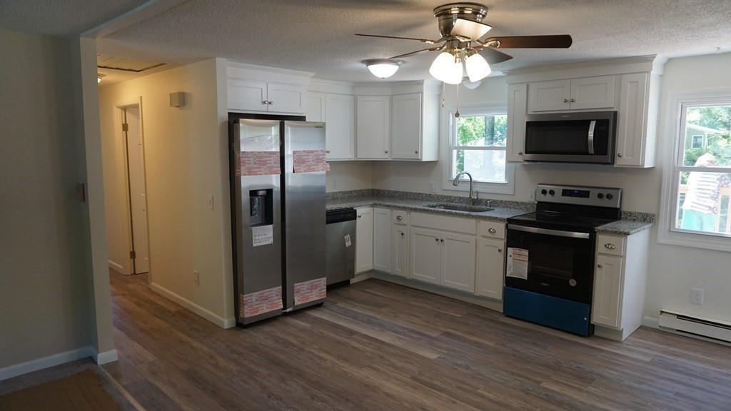 95 Sierra Vista Road Springfield, MA 01128 - Photo 5 of 28 a kitchen with stainless steel appliances granite countertop a stove a refrigerator and a microwave