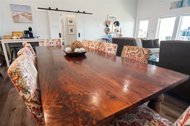 a living room with furniture a flat screen tv and a large window