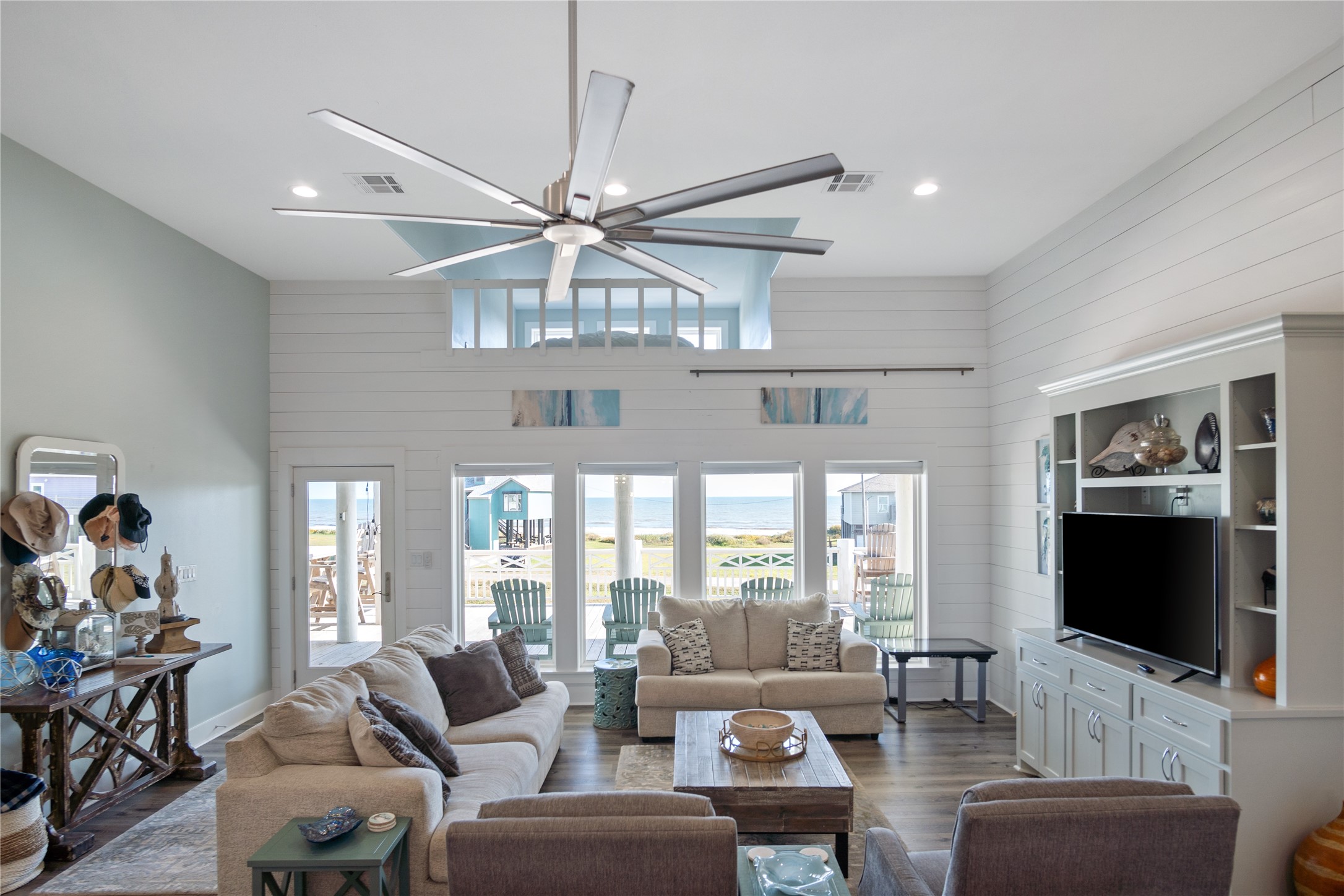940 Raymond Port Bolivar, TX 77650 - Photo 17 of 46 a living room with furniture a flat screen tv and a chandelier