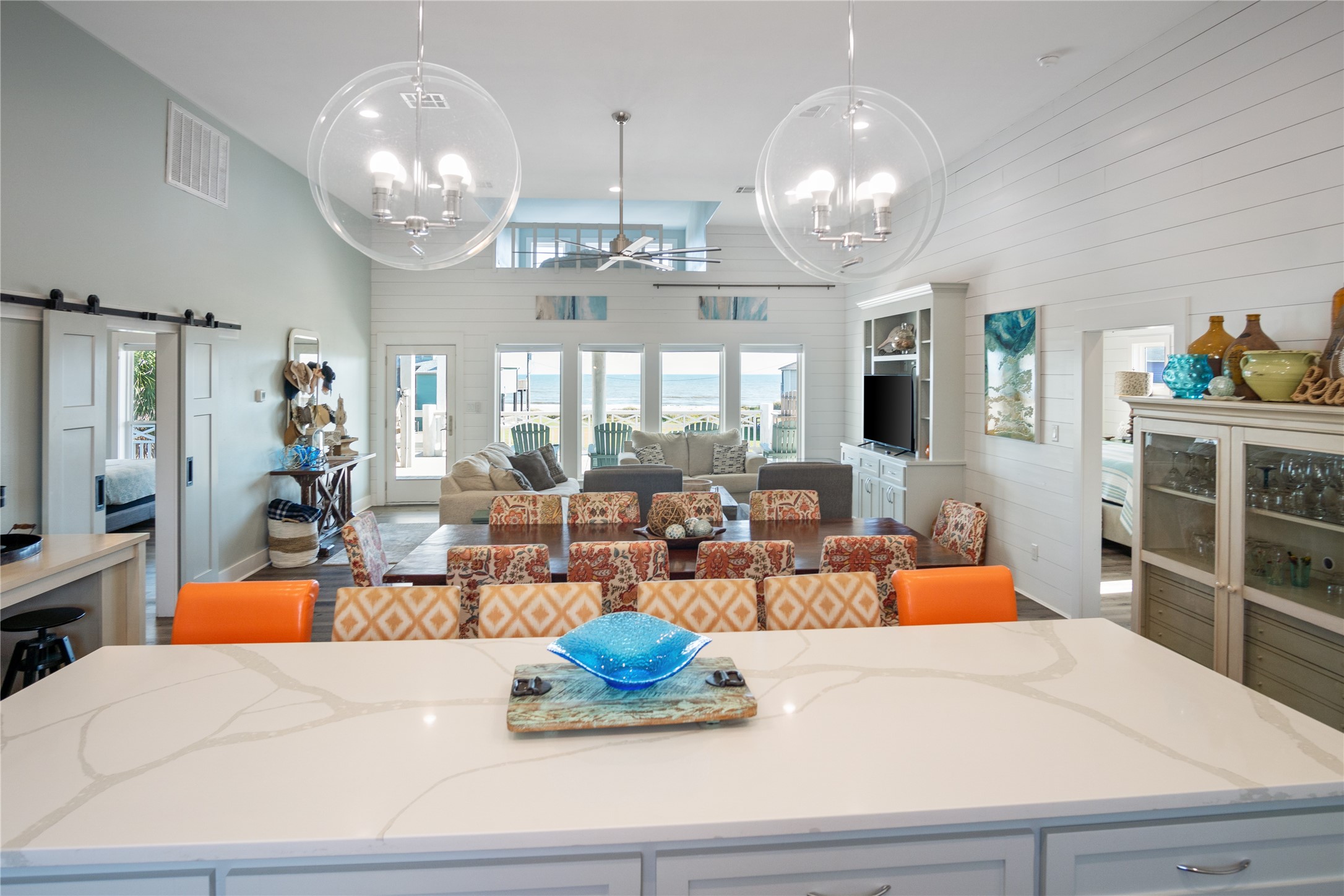 940 Raymond Port Bolivar, TX 77650 - Photo 7 of 46 a large living room with large couches chandelier and kitchen view