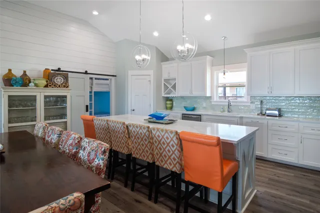 a kitchen with granite countertop white cabinets and white appliances