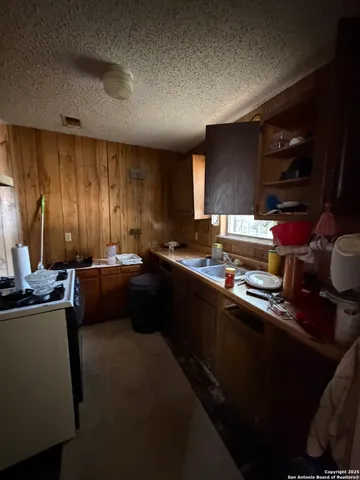 a kitchen with a sink cabinets and window