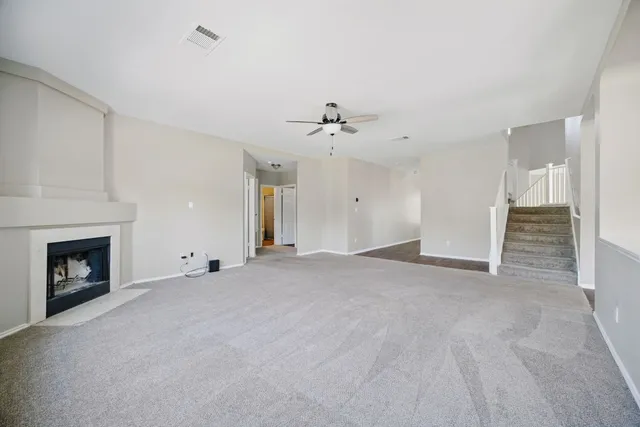 a view of an empty room with a fireplace