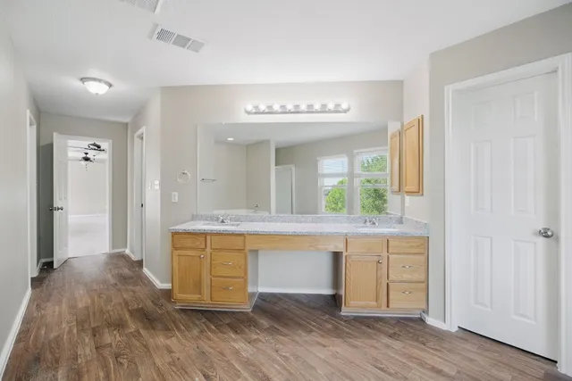 a large bathroom with a sink and a large mirror