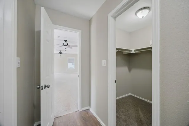 a view of a hallway with wooden floor