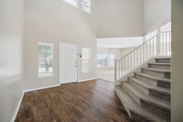 a view of entryway and hall with wooden floor
