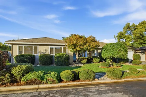 a front view of a house with a garden