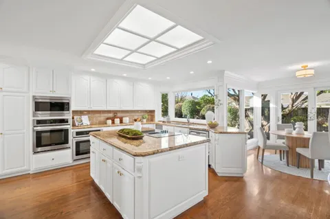 a kitchen that has a sink and a stove in it