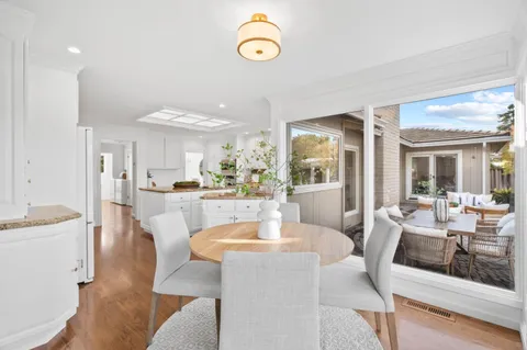 a view of a dining room with furniture and a table