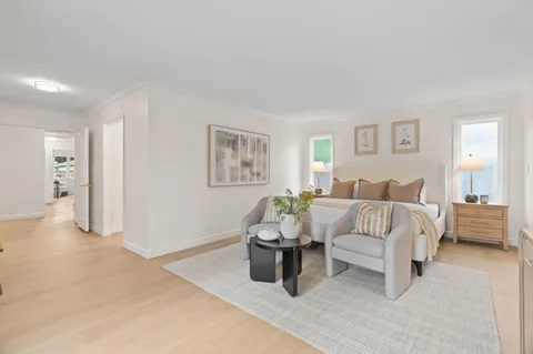 a bedroom with a white bed and white walls