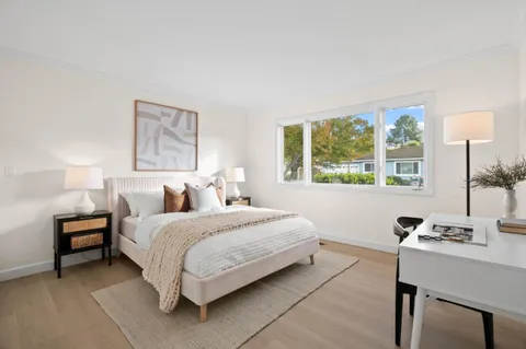 a bedroom with a bed and a desk