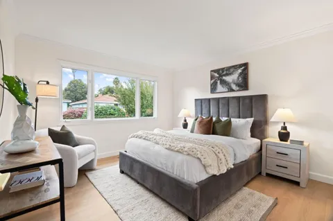 a bedroom with a large bed and a window