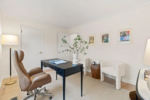 a view of a workspace with furniture and a couch