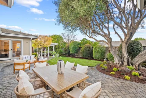 swimming pool view with a seating space and a garden