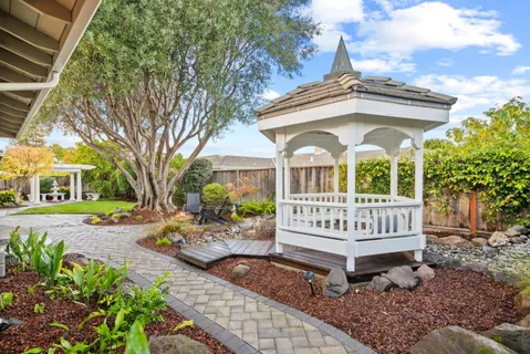 a view of a house with garden and deck