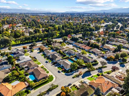 an aerial view of residential houses with outdoor space