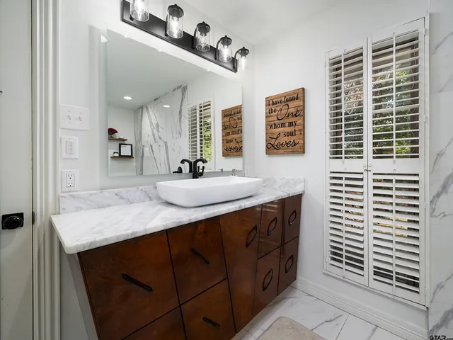 a bathroom with a sink vanity and a mirror