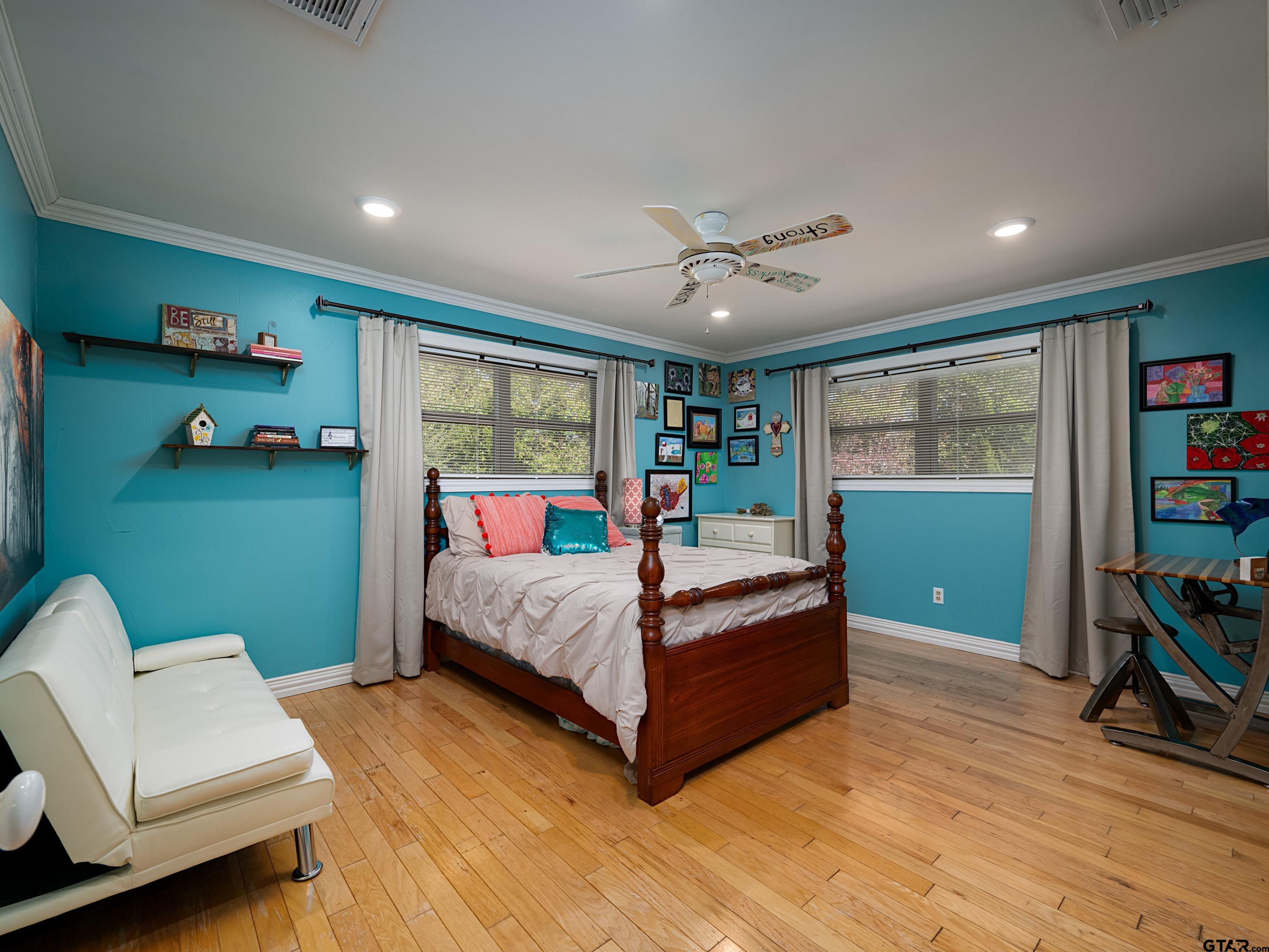 8212 Cambridge Road Tyler, TX 75703 - Photo 20 of 44 a bedroom with a bed and a chandelier