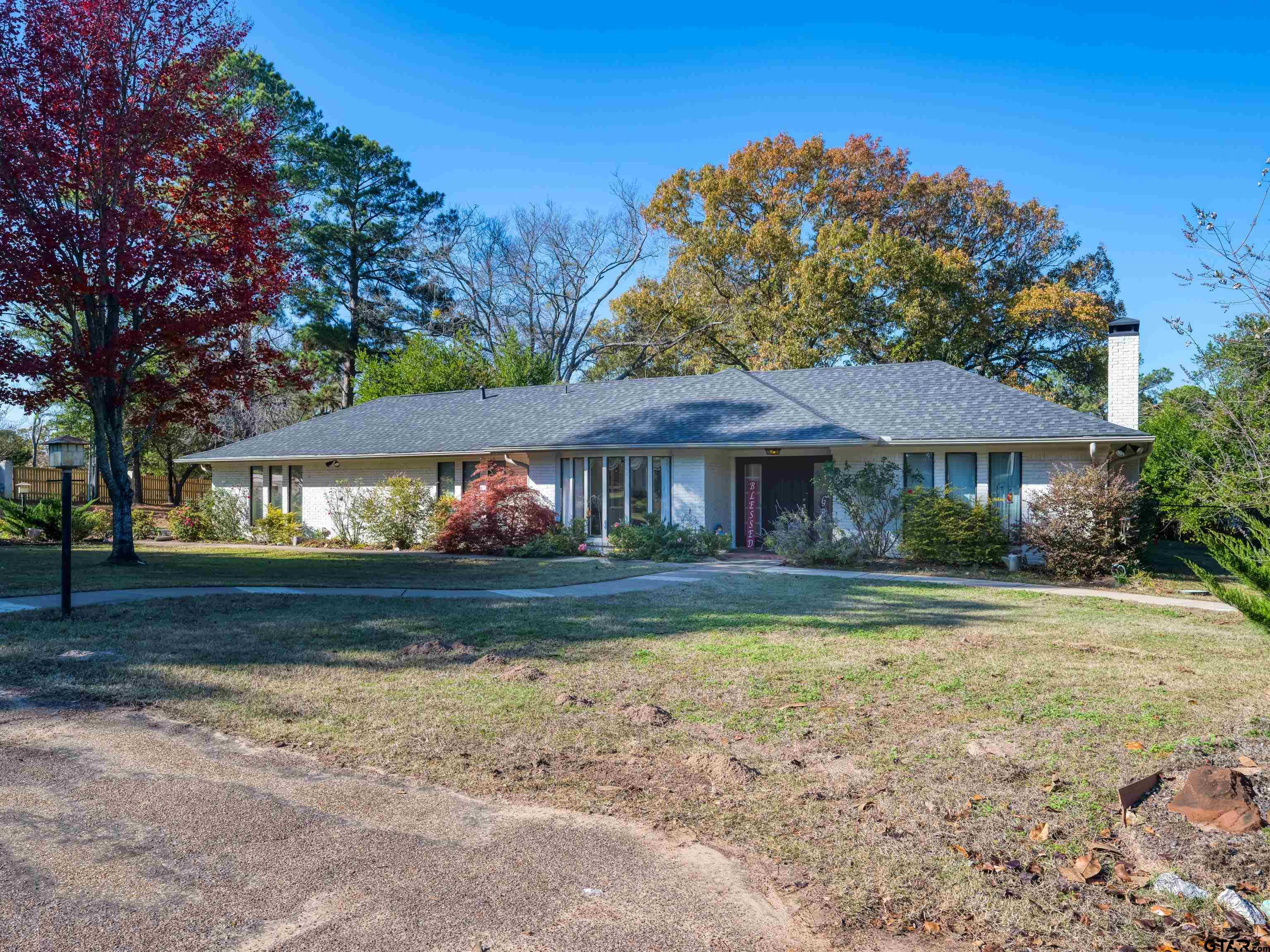 8212 Cambridge Road Tyler, TX 75703 - Photo 2 of 44 a front view of a house with a yard
