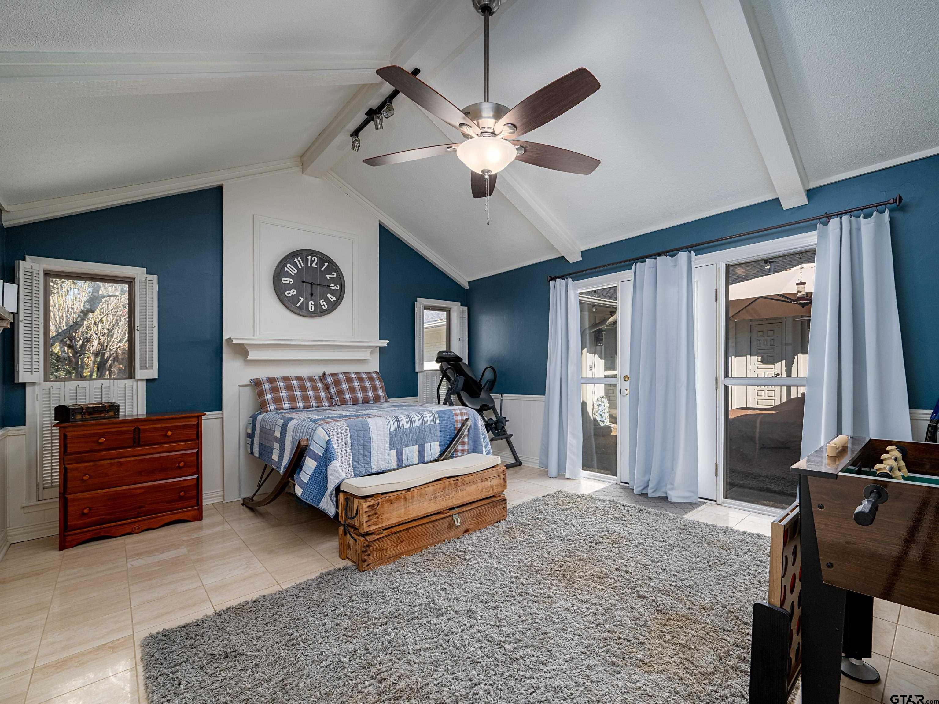 8212 Cambridge Road Tyler, TX 75703 - Photo 24 of 44 a bed room with a bed and a ceiling fan