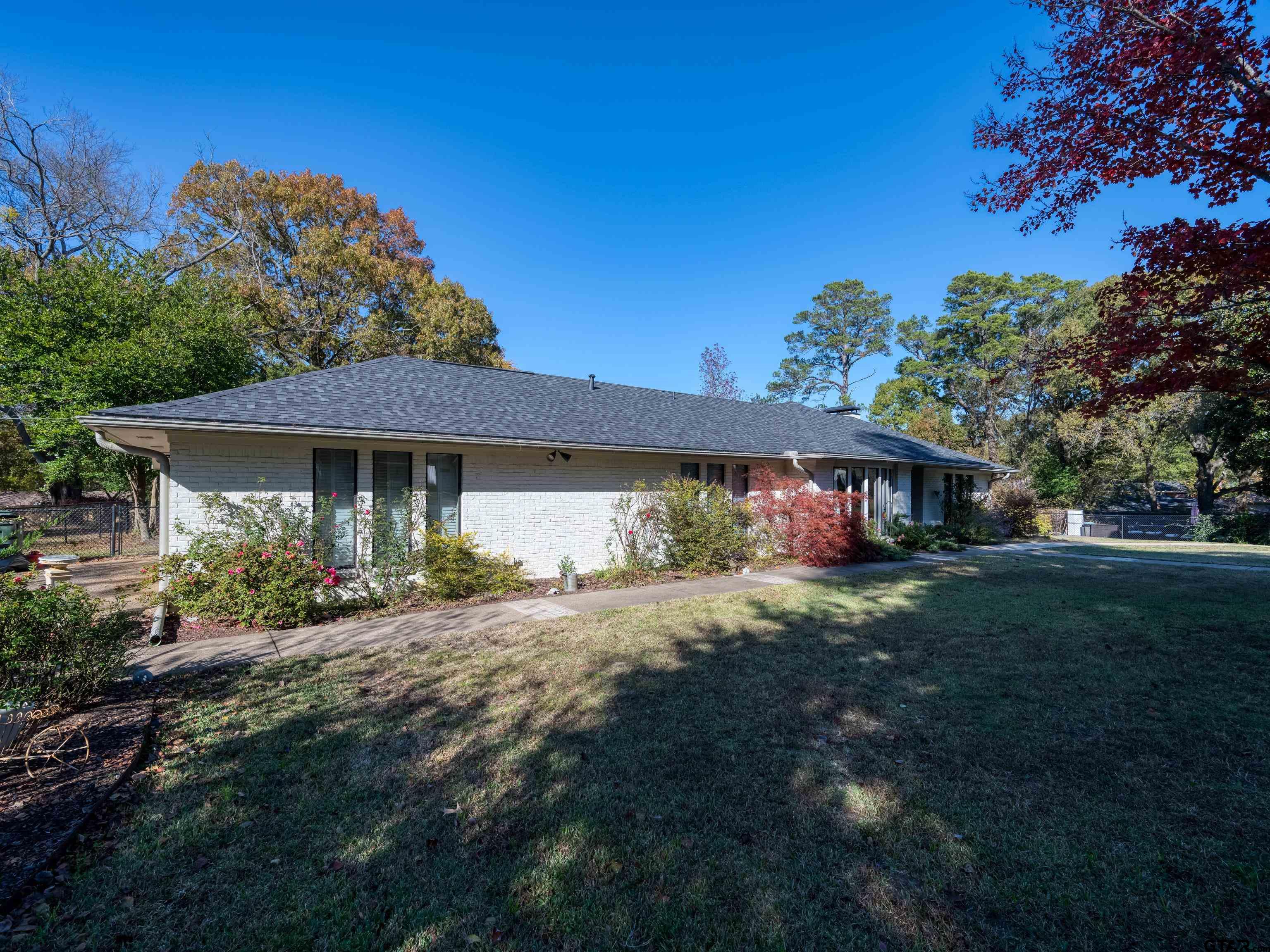 8212 Cambridge Road Tyler, TX 75703 - Photo 3 of 44 a front view of a house with a garden