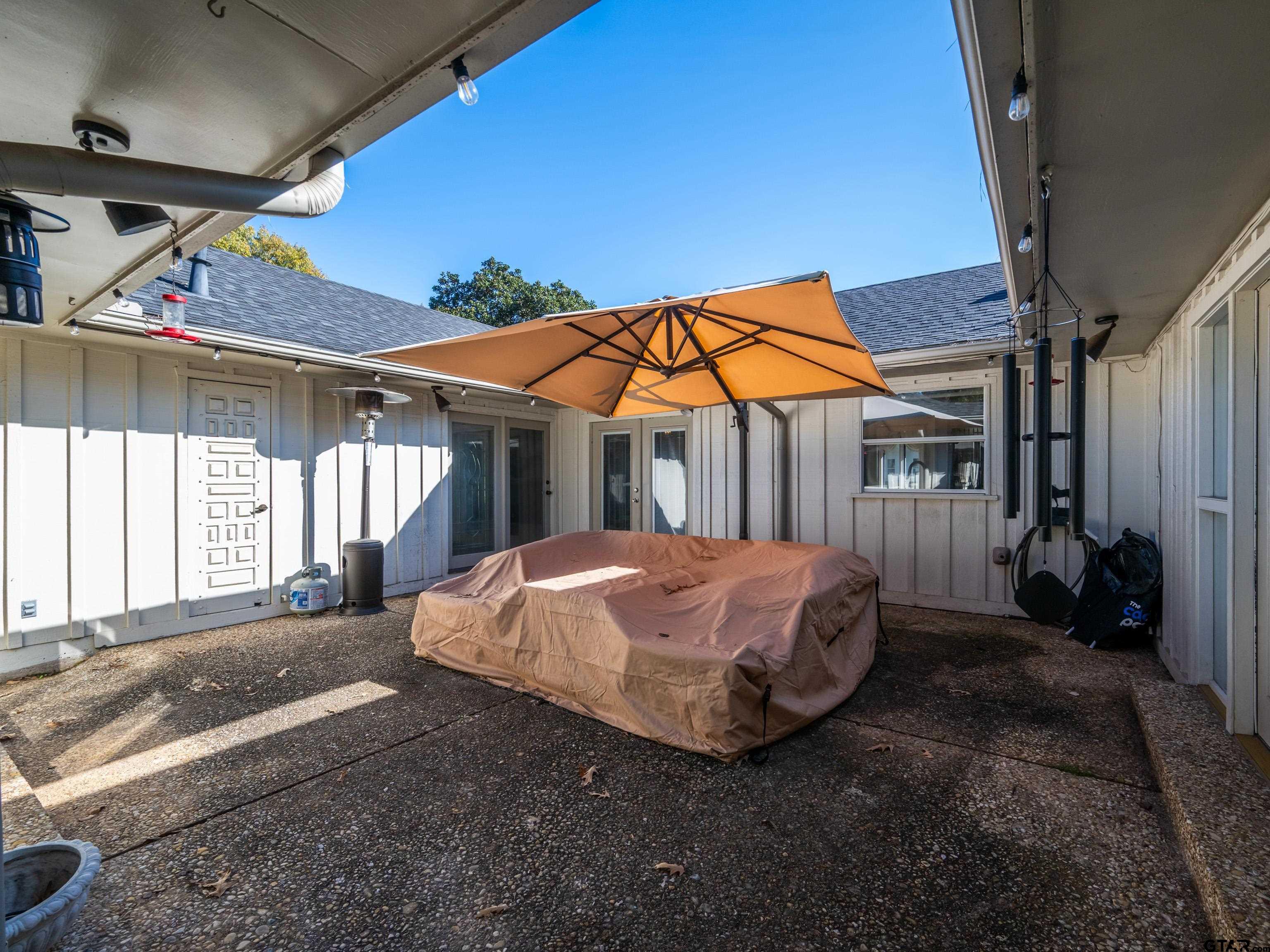 8212 Cambridge Road Tyler, TX 75703 - Photo 32 of 44 a view of a house with backyard and porch