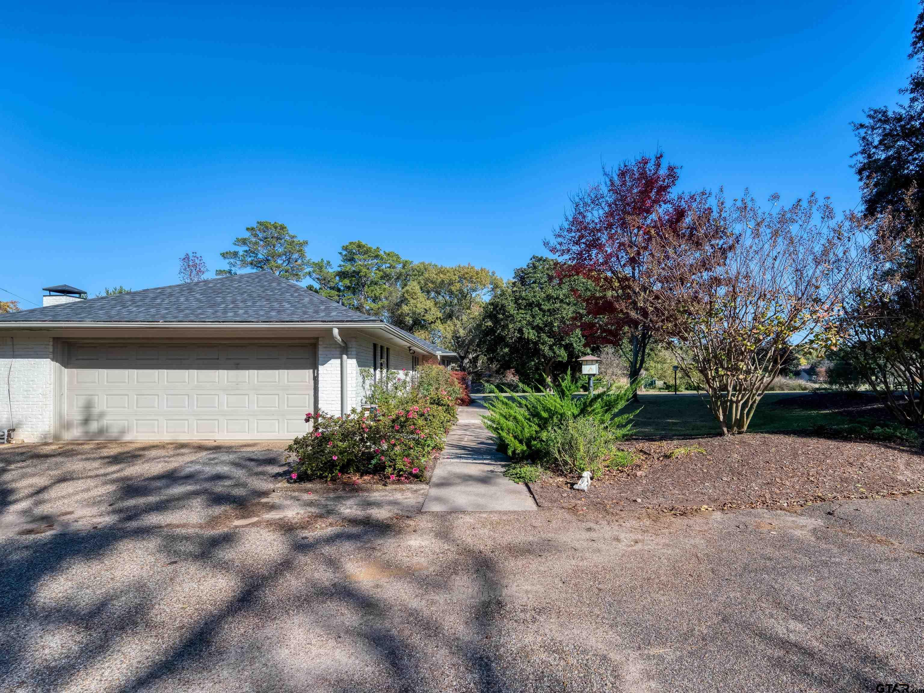8212 Cambridge Road Tyler, TX 75703 - Photo 5 of 44 a front view of a house with a yard