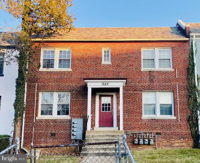 1649 Trinidad Avenue Northeast Washington, DC 20002 - Photo 13 of 18 front view of a brick house with a small yard