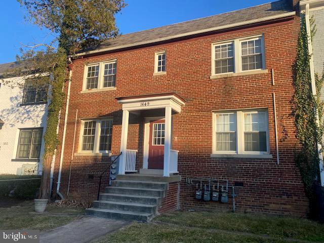 1649 Trinidad Avenue Northeast Washington, DC 20002 - Photo 4 of 18 a front view of a house with a yard