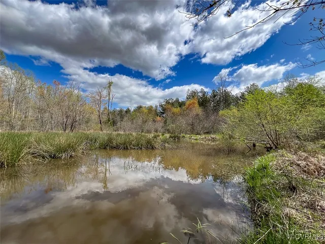 a view of lake with green space