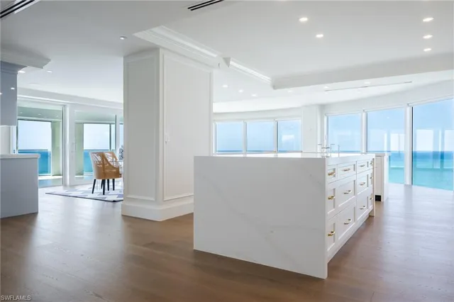 a view of a livingroom with furniture wooden floor and windows