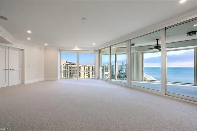 a view of an empty room with a sliding door and a window