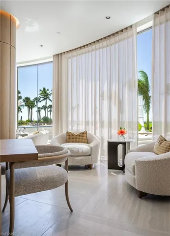 a living room with fireplace furniture and a floor to ceiling window