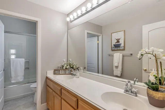 a view of a hallway with wooden floor and a living room