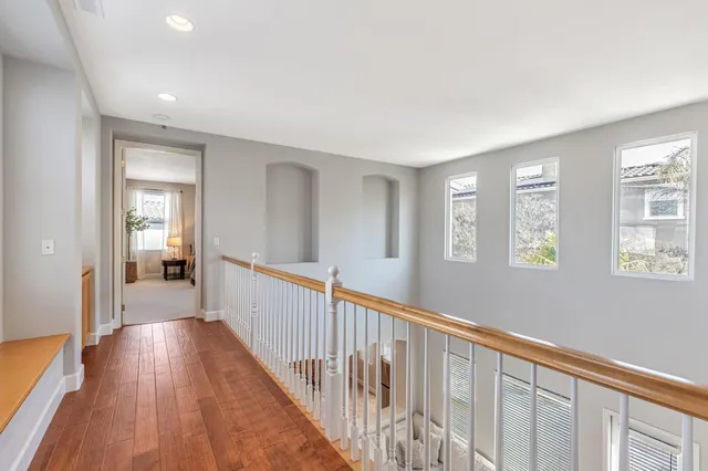 a spacious bedroom with a large bed and a chandelier fan