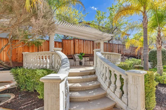 a front view of a house with a yard and plant