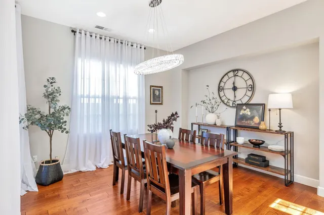 a view of a dining room with furniture and a chandelier