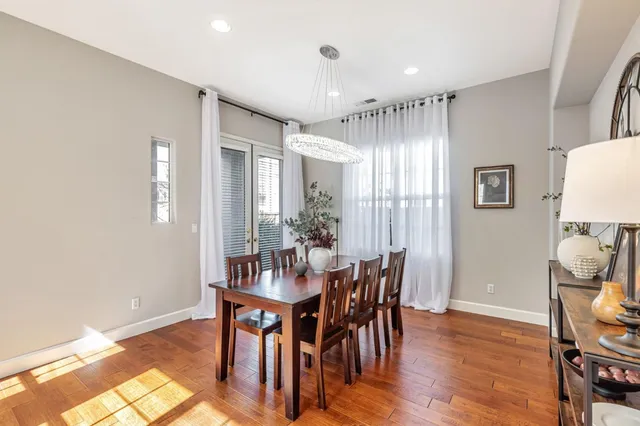 a view of a a dining room with furniture window and wooden floor